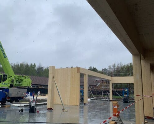 IMG_4034 Byggeplassen i regnvær med noen massivtre elementer på plass, foto.